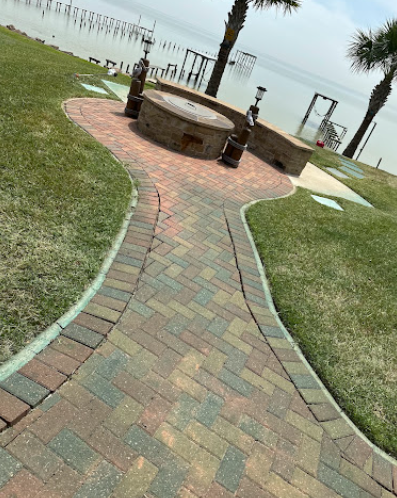 Curved paver walkway and seating wall built by Salgado Landscaping